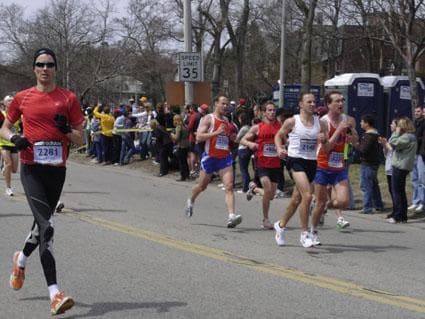 Runner number 2281 Shawn Husband of Savage, Minn. (far left), 2751 Matt Mallet of Ballston Spa, N.Y., 4802 Patrick Burke of San Diego, Calif., 2140 Jonathan Holland of Tannersville, Penn., and 3225 Dan Britton of Overland Park, Kan. top Heartbreak Hill on Monday in the Boston Marathon. (WBUR/Kathleen McNerney)