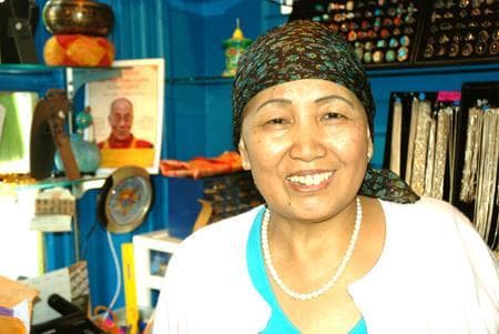 Tenzin Cheodon, owner of the Little Tibet gift shop in Harvard Square, has been granted a private audience with the Dalai Lama during his Massachusetts visit this week. She wants to ask the spiritual leader to name her grandchild. (Meghna Chakrabarti/WBUR)