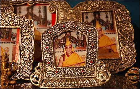 Images of the Dalai Lama are on display at Little Tibet in Harvard Square. Store owner Tenzin Cheodon says the Dalai Lama’s visit offers Tibetan refugees in New England a rare opportunity to see their spiritual leader. (Meghna Chakrabarti/WBUR)