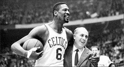 In this Dec. 12, 1964 file photo, Boston Celtics' Bill Russell, left, is congratulated by coach Arnold "Red" Auerbach after scoring his 10,000th career point during a basketball game against the Baltimore Bullets at the Boston Garden in Boston. As a coach, Red Auerbach got the most out of Bill Russell as a player not by yelling at him, or teaching him new techniques. He just talked to him man-to-man. Russell celebrates their relationship in a new book about Auerbach. (AP)