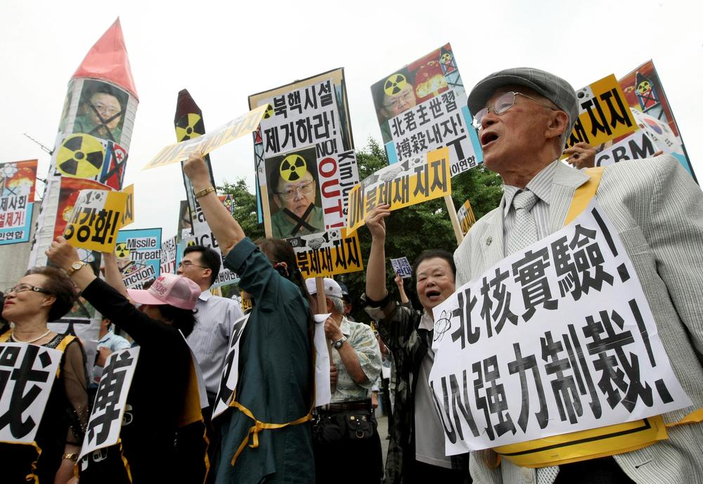 South Korean protesters and North Korean defectors shout slogans during a rally against North Korea's nuclear test and missiles in Seoul, South Korea, Tuesday, June 2, 2009. North Korea is preparing to launch three or four medium-range missiles, along with an intercontinental ballistic missile, amid moves by Kim Jong Il to anoint his third son as heir to the world's first communist dynasty, reports and experts said Tuesday. "The Korean reads "Remove North Korea nuclear."   (AP) 