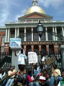 Critics of legislation designed to restrict access to criminal records gathered outside the State House in Boston on Monday. (Steve Brown/WBUR)