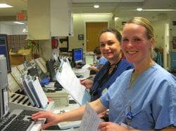 Shileen Kelley, left, and Allison Shannon are RNs in the Melrose-Wakefield Hospital emergency room. ER nurses say they've seen an increase in disturbances since the state began cutting the budget for mental health and substance abuse programs. (Fred Thys/WBUR)