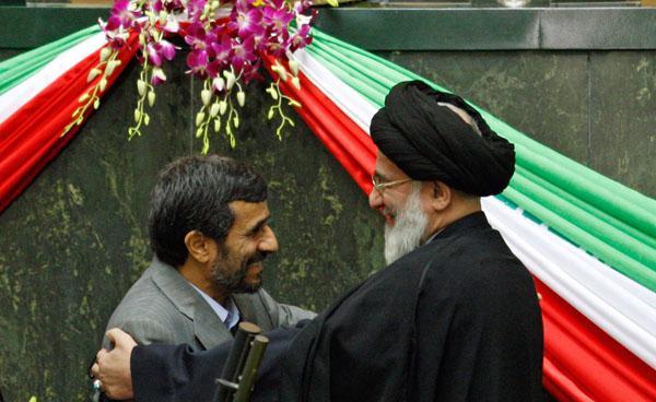 Iranian President Mahmoud Ahmadinejad embraces judiciary chief Ayatollah Mahmoud Hashemi Shahroudi during the swearing-in ceremony for his second term in an open session of parliament in Tehran. (AP Photo/Vahid Salemi)