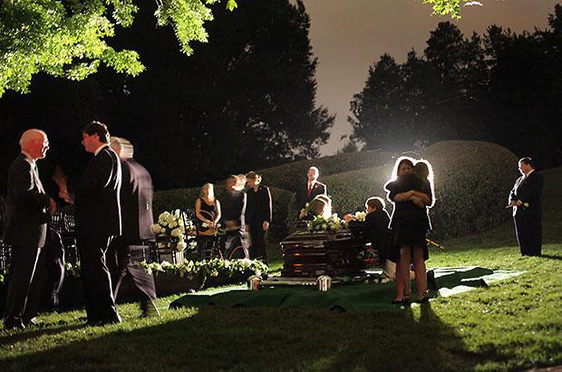 Family members gather at the coffin of Sen. Edward M Kennedy at a private burial at Arlington National Cemetery on Saturday. (Doug Mills, Pool/Via AP)