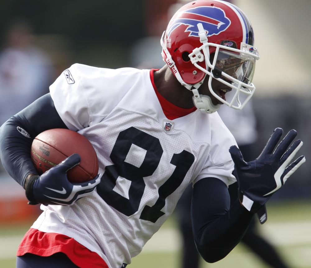 Buffalo Bills' Terrell Owens runs after a catch during NFL football training camp at St. John Fisher College in Pittsford, N.Y., Sunday, July 26, 2009. (AP Photo/David Duprey)