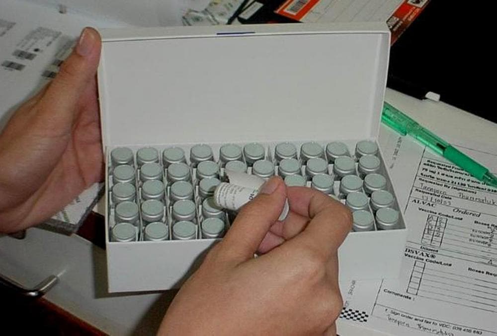 In this 2005 photo released Thursday by the Thai Public Health Ministry, a lab technician holds up an AIDS vaccine vial at the Armed Forces Institute of Medical Science in Bangkok. Researchers in Thailand reported for the first time that an experimental vaccine has prevented infection with the AIDS virus. (AP)