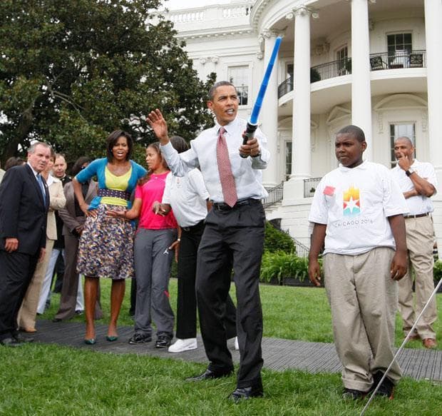 In this Sept. 16 file photo, President Obama uses a light saber as he watches a fencing demonstration at an event supporting Chicago's 2016 host city Olympic bid on the South Lawn of the White House. (AP)