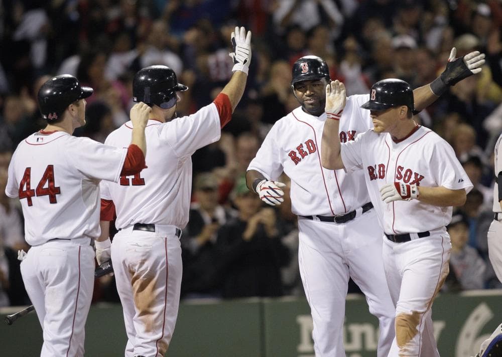Boston Red Sox's Jason Bay (44), Casey Kotchman (11) and David Ortiz celebrate with J.D. Drew, far right, after Drew hit a three-run home run in the eighth inning against the Toronto Blue Jays at Fenway Park on Tuesday. (Elise Amendola/AP)