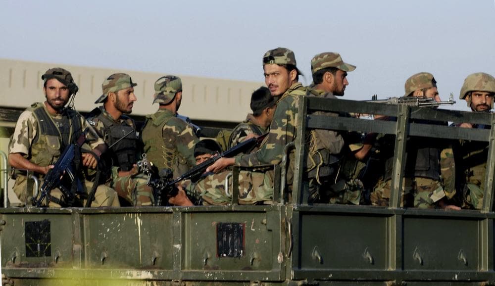 Pakistani army troops return to base camp after conducting an operation at their own army's headquarters in Rawalpindi, Pakistan on Sunday. Pakistani commandos raided their own army's headquarters Sunday to free 30 people held hostage by Islamist fighters. (AP/Anjum Naveed)