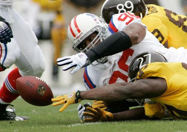 New England Patriots Adalius Thomas (96) reaches for a Denver Broncos running back Knowshon Moreno (27) fumble in the first quarter during an NFL football game at Invesco Field in Denver Colo., on Sunday. (Barry Gutierrez/AP)