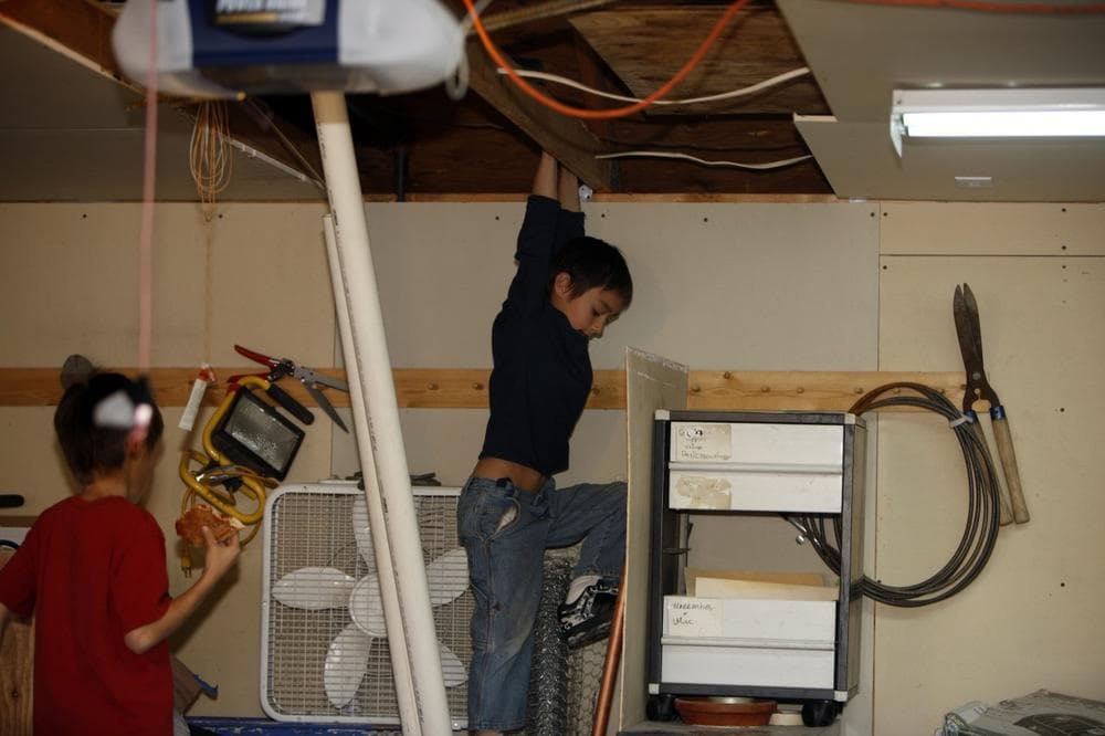Six-year-old Falcon Heene, back, shows where he was hidden as his 10-year-old brother, Bradford, looks on in the family's home in Fort Collins, Colo. (AP/David Zalubowski)