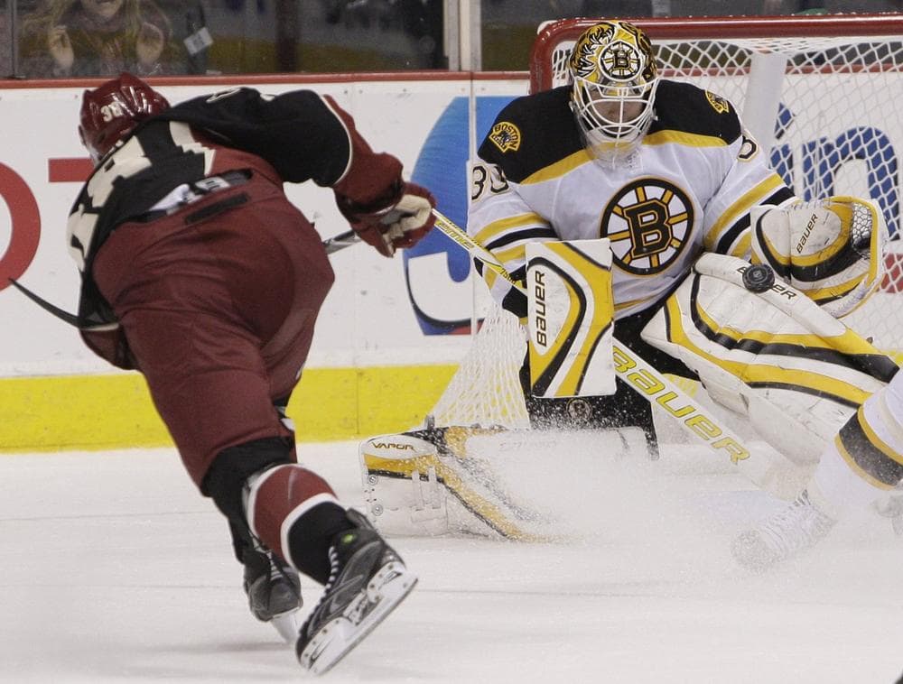 Boston Bruins' Tim Thomas, right, makes a save on a shot by Vernon Fiddler, left, during the third period Saturday, in Glendale, Ariz.  (AP Photo/Ross D. Franklin)