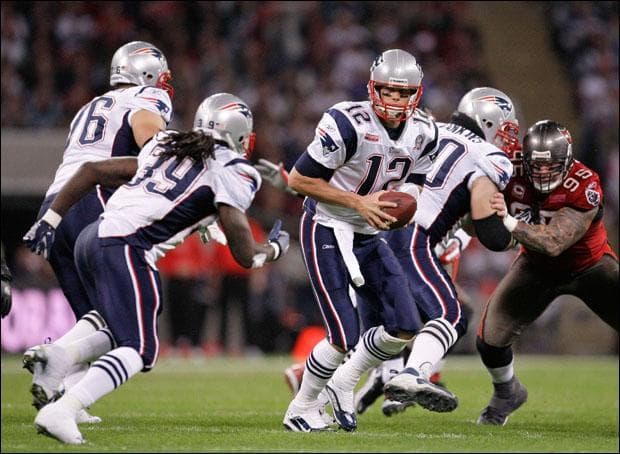 Tom Brady hands the ball off to running back Laurence Maroney during a game against the Tampa Bay Buccaneers in London on Sunday. (Matt Dunham/AP)