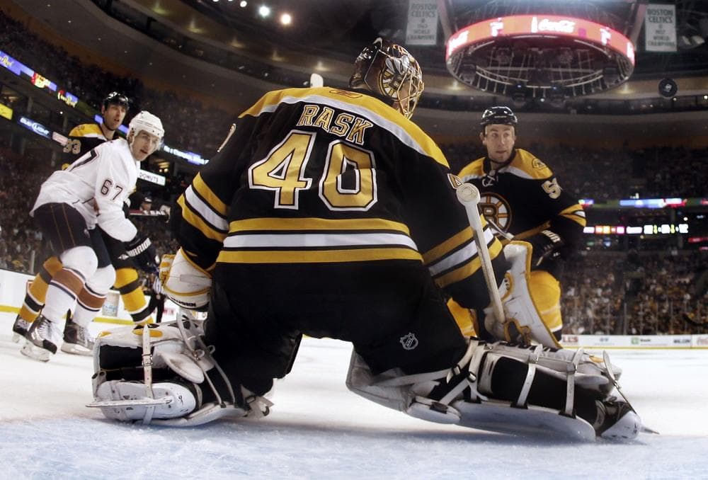 Bruins goalie Tuukka Rask (40) makes a save as Oilers center Gilbert Brule (67) looks for the rebound with  Boston defenseman Derek Morris, right, in Boston, Saturday. (AP/Winslow Townson)