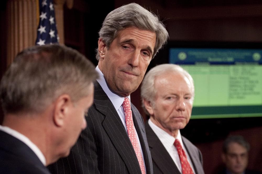Sen. John Kerry, accompanied by Sen. Lindsey Graham, left, and Sen. Joseph Lieberman, takes part in a news conference on Capitol Hill in Washington, Wednesday, to discuss climate change legislation. (AP)