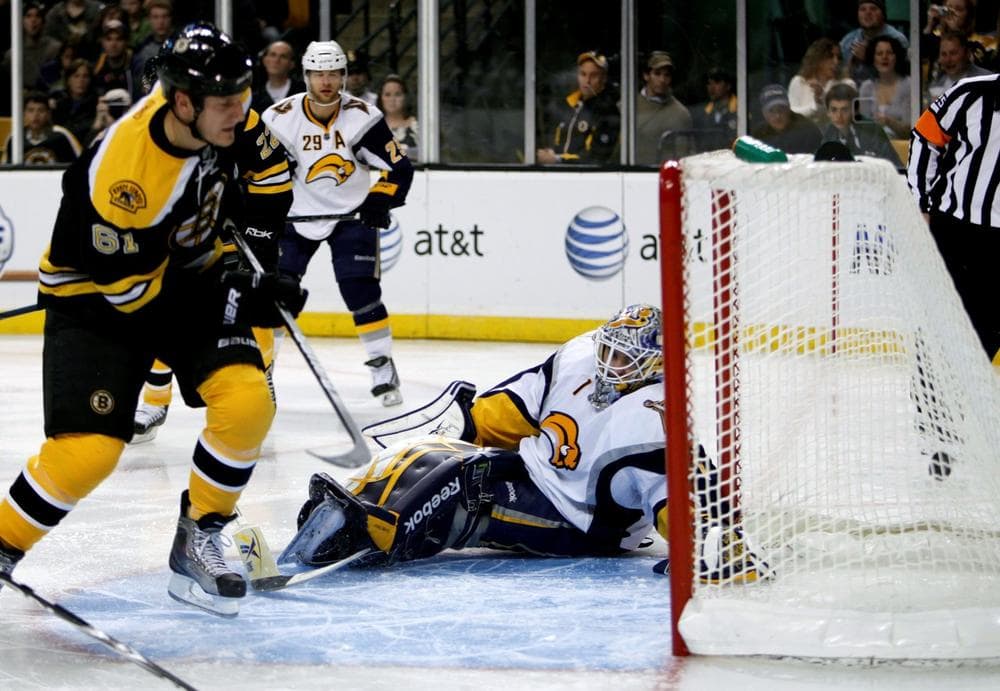 Bruins' Byron Bitz, left, scores on Sabres' Jhonas Enroth in the second period in Boston. (AP Photo/Michael Dwyer)