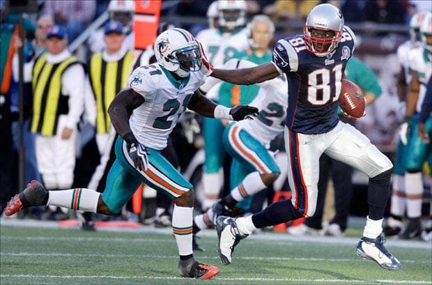 Wide receiver Randy Moss pushes off Miami Dolphins cornerback Vontae Davis on his touchdown reception on Sunday. (Charles Krupa/AP)