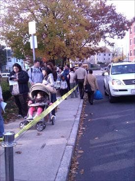 Hundreds wait outside Uphams Corner Health Clinic in Dorchester for the H1N1 vaccine. (Steve Brown/WBUR)