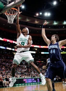 Rajon Rondo lays up the ball in front of Utah Jazz's Kyrylo Fesenko on Wednesday. (Michael Dwyer/AP)