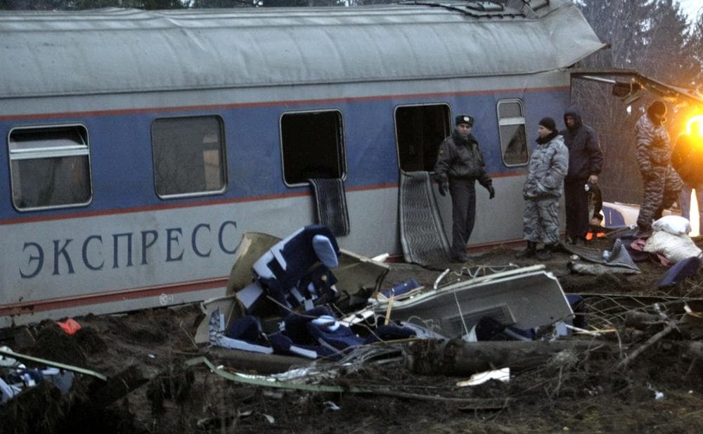 Russian police officers inspect a damaged coach at the site of a train derailment near the town of Uglovka, some 400 km (250 miles) north-east of Moscow, Russia on Saturday. (AP Photo/Ivan Sekretarev)