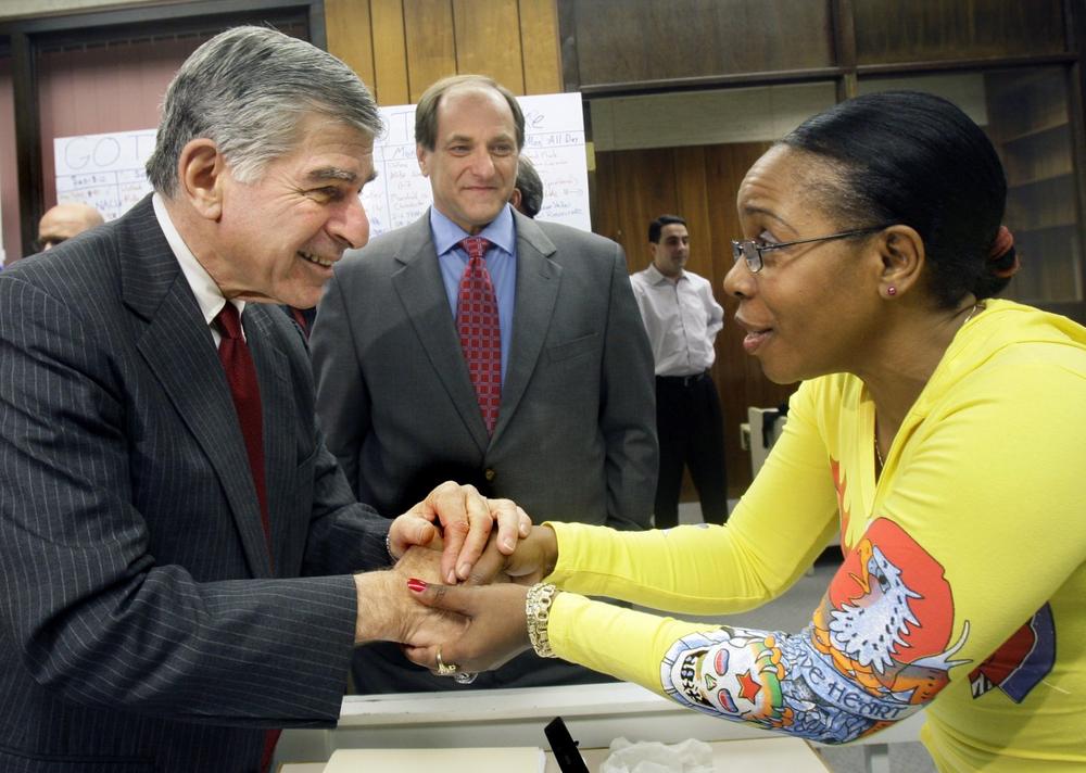 Former Gov. Michael Dukakis greets a volunteer as Rep. Michael Capuano smiles at his campaign headquarters in Worcester on Monday. (AP) 