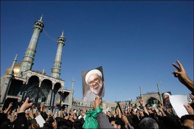 Pro-reform Iranians attend the funeral ceremony of Grand Ayatollah Hossein Ali Montazeri, the spiritual father of Iran's reform movement, in the holy city of Qom on Monday. (AP)