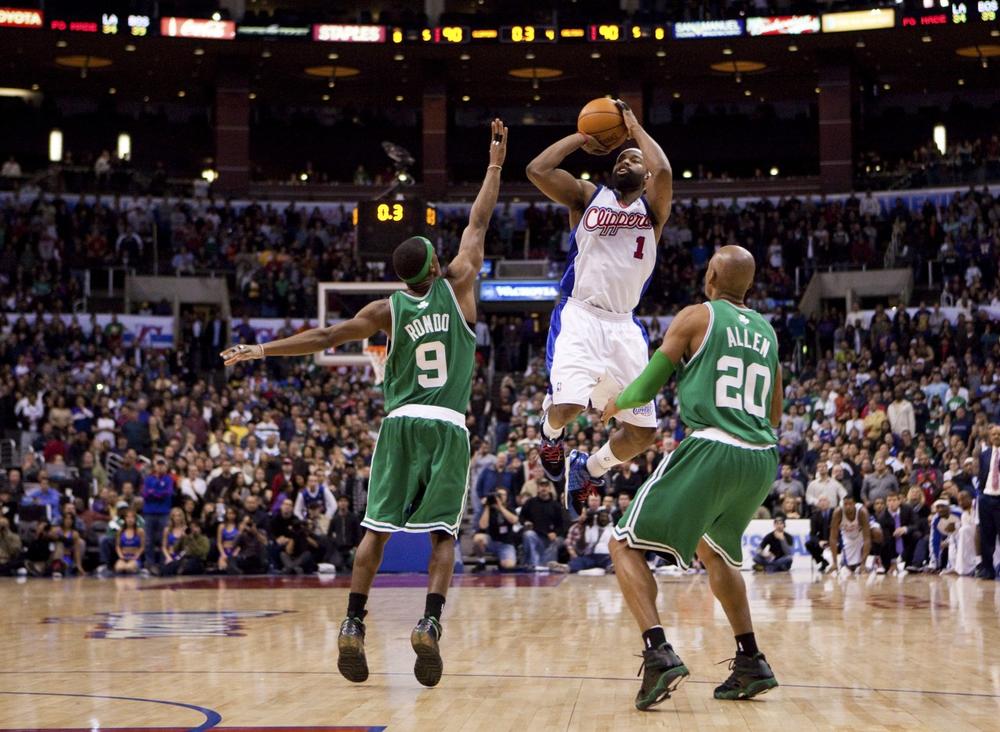 Los Angeles Clippers' Baron Davis hits the game-winning shot while being guarded by Boston Celtics' Rajon Rondo and Ray Allen to defeat the Celtics 92-90 on Sunday, Dec. 27 in Los Angeles. (AP)