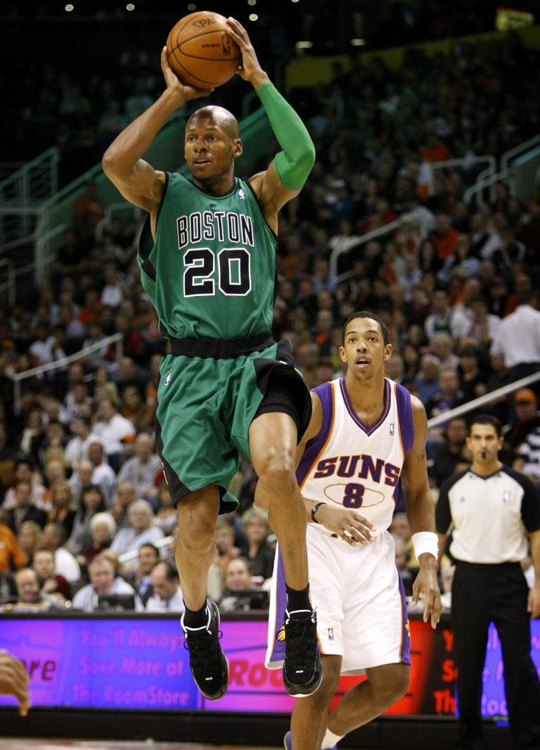 Boston Celtics' Ray Allen (20) looks to pass as Phoenix Suns' Channing Frye (8) looks on during the first half of an NBA basketball game Wednesday, Dec. 30, 2009, in Phoenix. (AP Photo/Matt York)