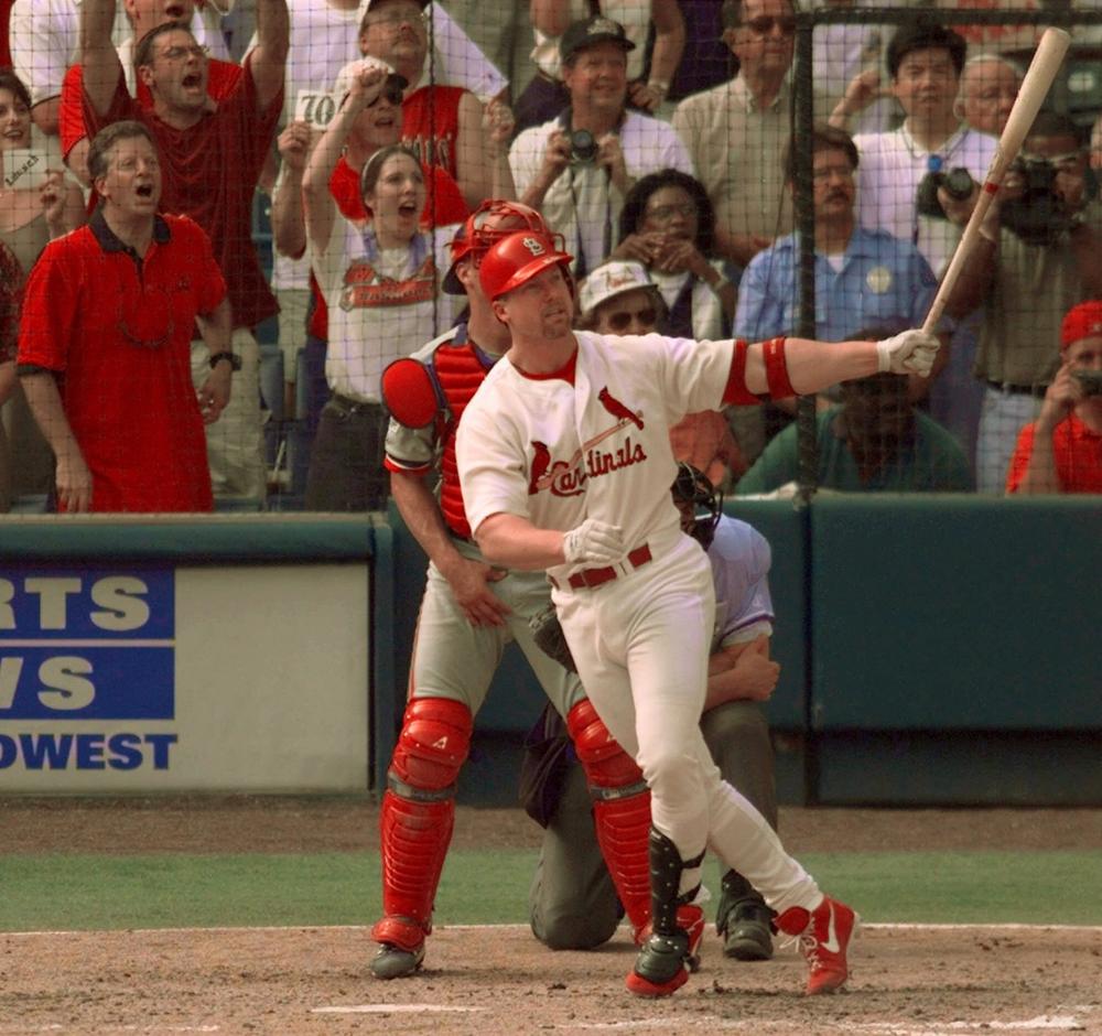 Mark McGwire watches the flight of his 70th home run of the season, Sept. 27, 1998, at Busch Stadium in St. Louis. (AP)