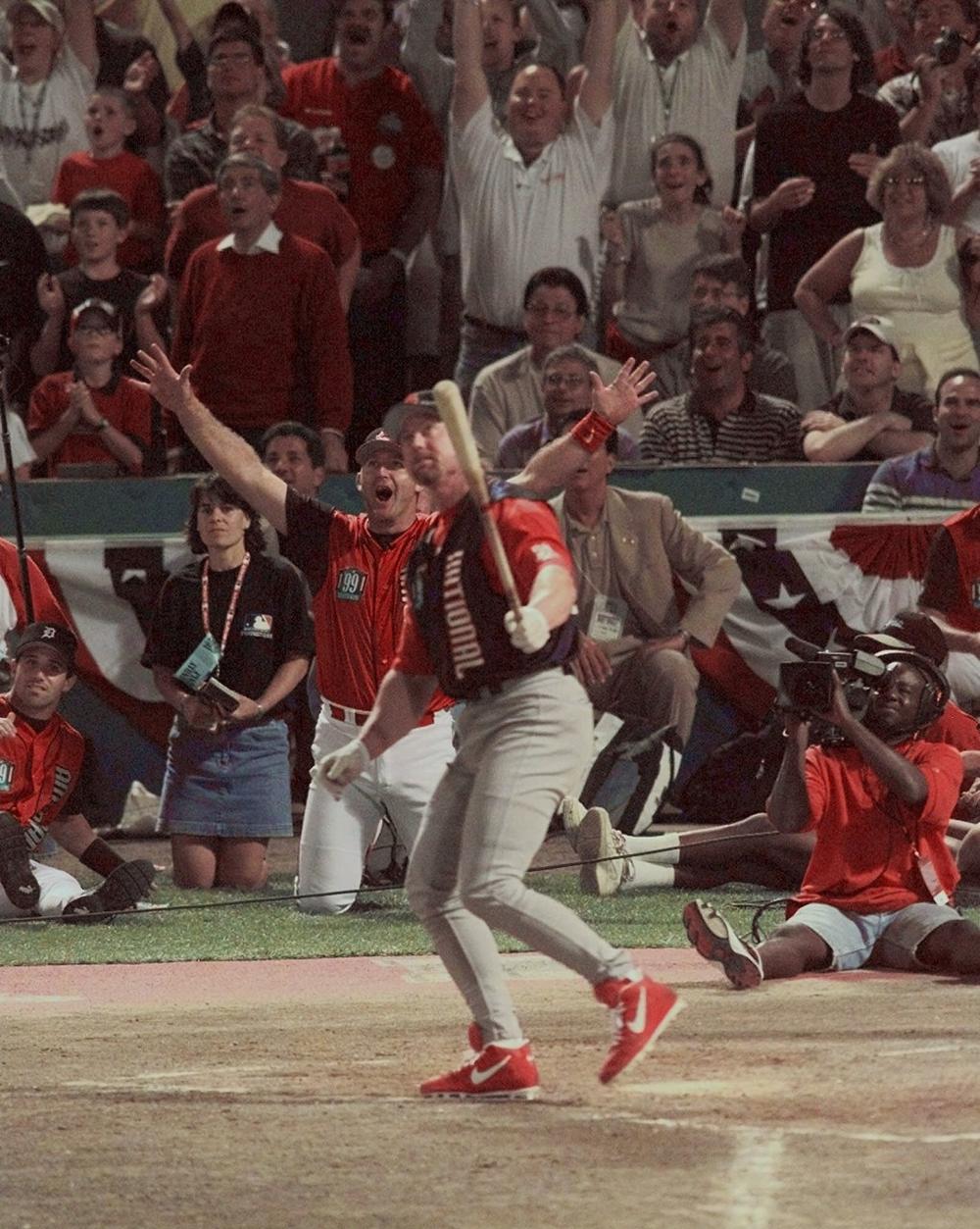Mark McGwire watches the flight of one of of his 13 home runs during the first round of the All-Star home run contest at Fenway Park in July 1999. (AP)