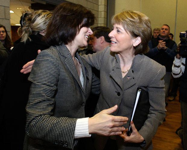 Mass. Attorney General Martha Coakley, right, hugs Victoria Reggie Kennedy,  widow of Sen. Edward M. Kennedy, during a stop in Boston on Saturday. (Charles Krupa/AP)