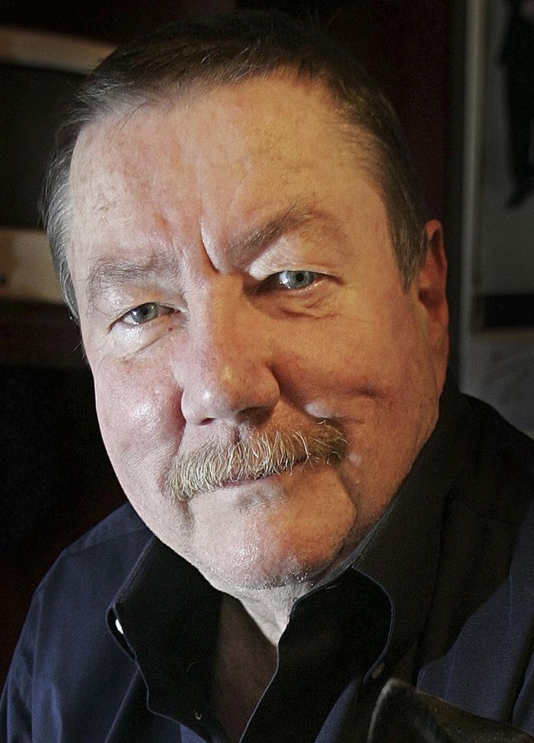 In this Jan. 30, 2006 file photo, author Robert Parker poses in his Cambridge office. The author of the popular "Spenser" books about a hard-nosed Boston private investigator died Monday in Cambridge. He was 77.  (AP)