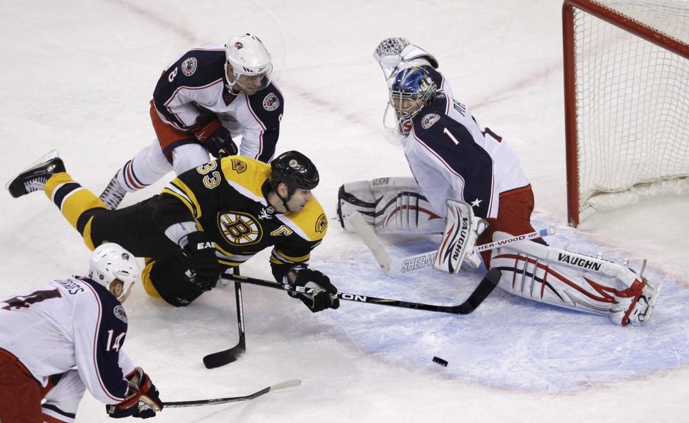 Boston Bruins defenseman Zdeno Chara (33), of Slovakia, dives toward the puck as Columbus Blue Jackets goalie Steve Mason, right, makes a save in the final seconds of the third period of Thursday's game (AP Photo/Charles Krupa).
