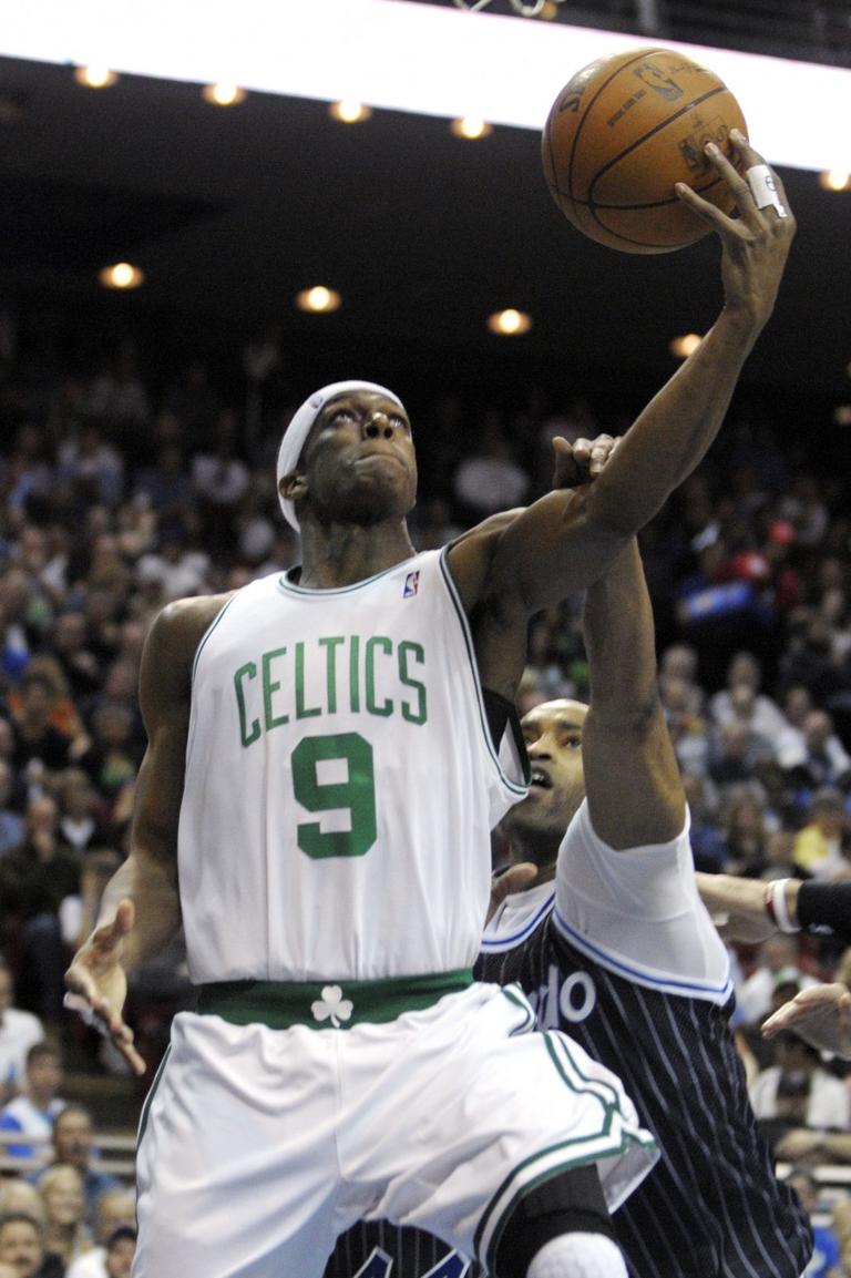 Boston Celtics guard Rajon Rondo, left, goes up for a shot in front of Orlando Magic guard Vince Carter during the first half of Thursday's game. (AP Photo/Phelan M. Ebenhack)