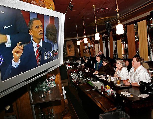 Members of the New Hampshire Young Democrats watch President Obama give his State of the Union address at Martha's Exchange in Nashua, N.H. on Wednesday. (AP)