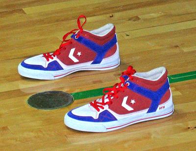 Cummings places this pair of sneakers behind the basket while he shoots. He says they remind him of the members of the military who are away from their homes and families. (Doug Tribou/WBUR)