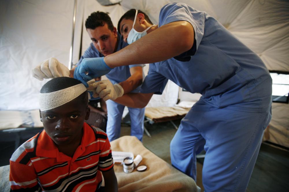 In this photo released by MINUSTAH, an injured youth is attended by medics in a field hospital at the Jordanian battalion's base in Port-au-Prince, Tuesday, Jan. 19, 2010. The U.N. Security Council approved extra troops and police officers to beef up security in Haiti and ensure that desperately needed aid gets to earthquake victims. A 7.0-magnitude earthquake struck Haiti on Jan. 12. (AP/MINUSTAH)