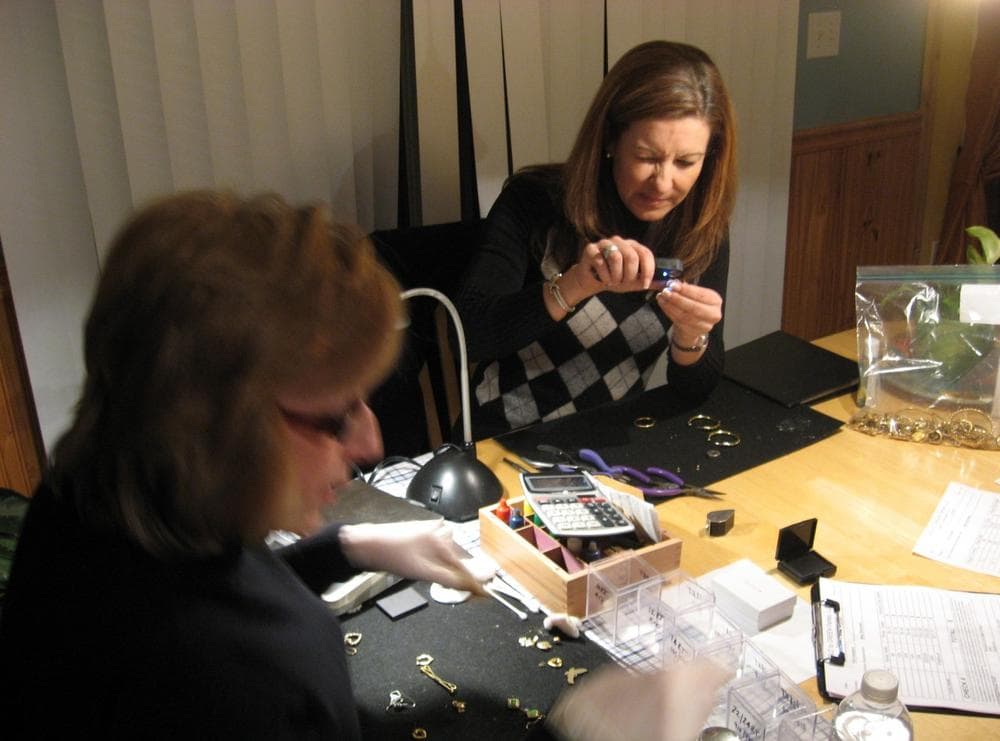 Laurie Souza, right, a former mortgage wholesale representative, runs a business that organizes cash-for-gold parties. (Curt Nickisch/WBUR)