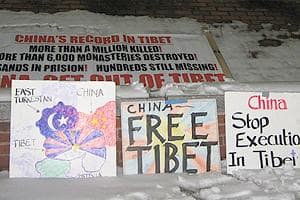 Tibetans at the Harvard Square vigil bring signs and banners, expressing their cause. (Karen Pelland/WBUR)