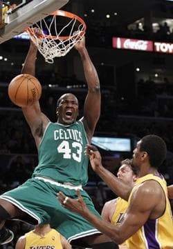 Boston Celtics center Kendrick Perkins (43) dunks over Los Angeles Lakers forward Ron Artest, right, during the second half of Thursday's game.(AP Photo/Lori Shepler)