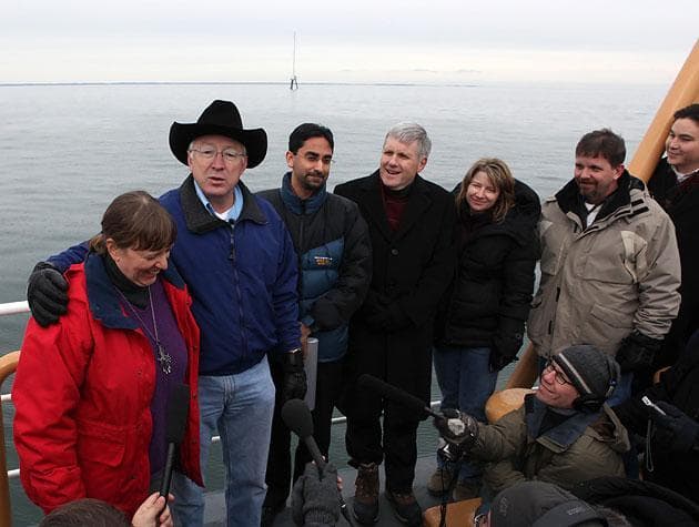 Interior Secretary Ken Salazar, second from left, puts an arm around Minerals Management Service Director Liz Birdbaum, far left, during a news conference aboard the Coast Guard's Ida Lewis buoy tender on a tour of Nantucket Sound on Feb. 2. (Julia Cumes/AP)