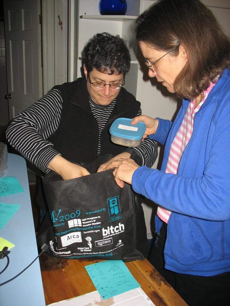 Gail and Betsy Leondar-Wright, of Arlington, pack up dinner for someone as part of the Time Trade Circle. (Photo by Monica Brady-Myerov/WBUR)