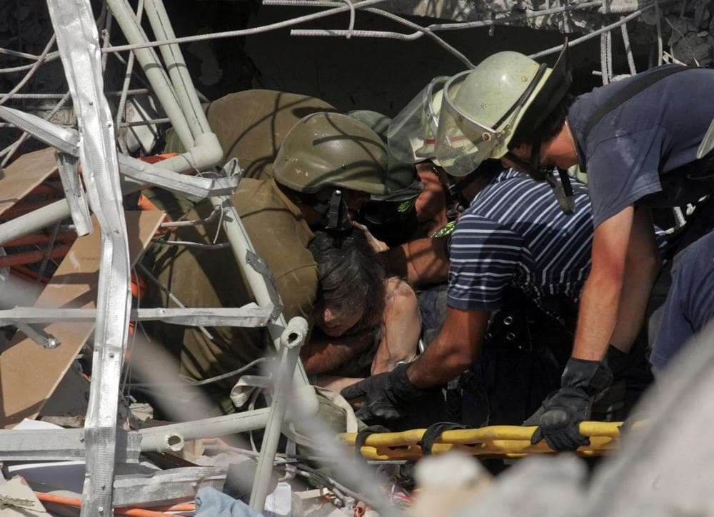 Rescue workers pull out of the rubble an earthquake survivor in Concepcion, southern Chile, Saturday. An 8.8-magnitude earthquake, which epicenter was just 70 miles from Concepcion, Chile's second-largest city, struck central Chile early Saturday. (AP Photo)