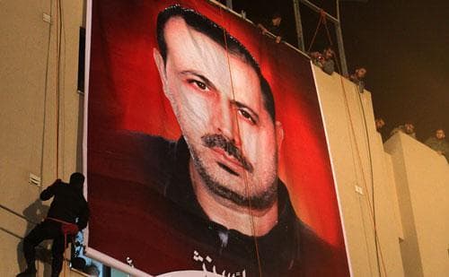 Palestinian Hamas militants participate in a rally for the memory of Hamas commander Mahmoud al-Mabhouh, seen in the portrait, in the town of Beit Lahiya, northern Gaza Strip, on Feb. 17, 2010. (AP)