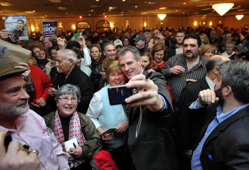 Sen.-elect Scott Brown takes a photo with Sandra Curtiss, of Chatham, as he greets supporters in Foxborough at the final stop of his three-day "thank you"  tour across the state. (AP)