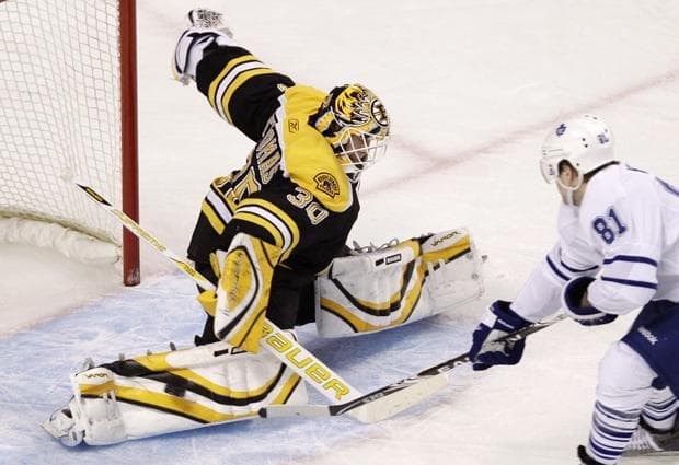 Bruins goalie Tim Thomas, left, makes a save on a shot by Maple Leafs right wing Phil Kessell during Thursday's game in Boston. (AP)