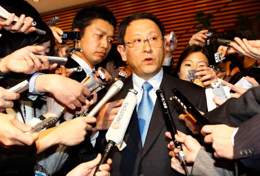Toyota President Akio Toyoda, center, answers reporters' questions after a meeting with Japanese Prime Minister Yukio Hatoyama in Tokyo on Monday. (AP)