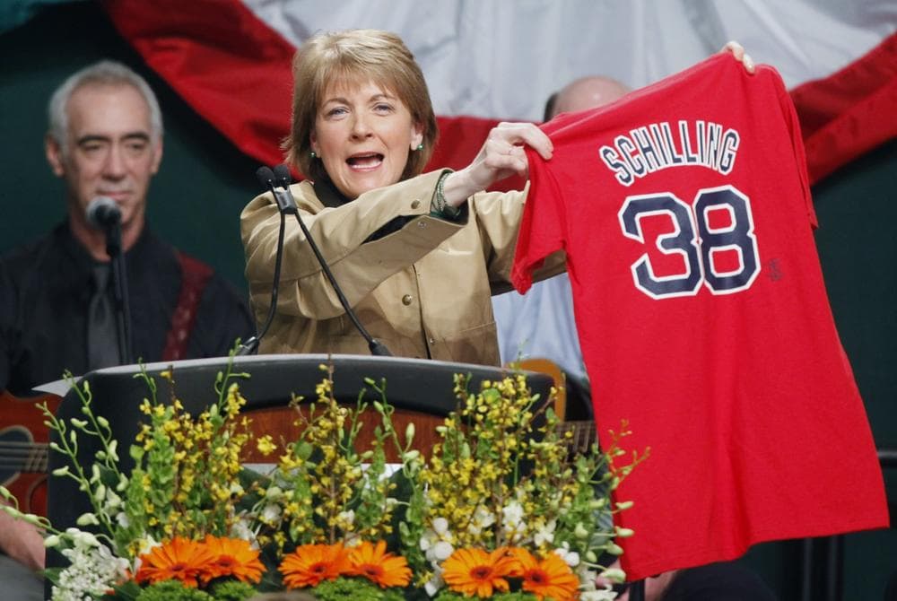 Massachusetts Attorney General Martha Coakley holds up a Red Sox jersey while speaking at the annual St. Patrick's Day breakfast in Boston on Sunday.  (AP)