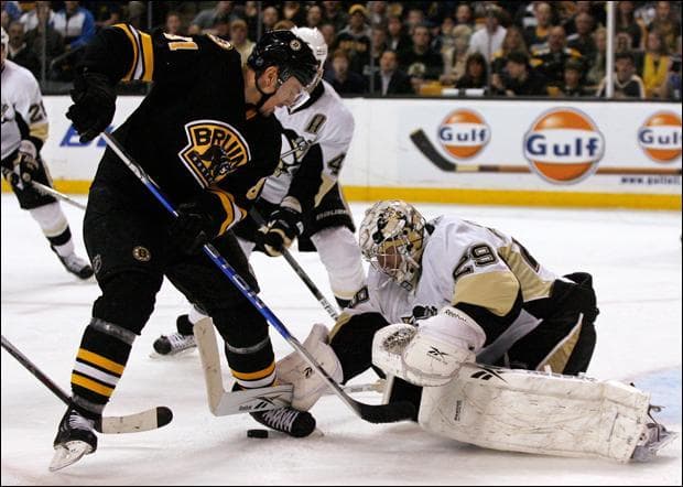 Pittsburgh Penguins goalie Marc-Andre Fleury makes a move for the puck as Boston Bruins' Miroslav Satan looks for a rebound during the second period on Thursday. (Mary Schwalm/AP)